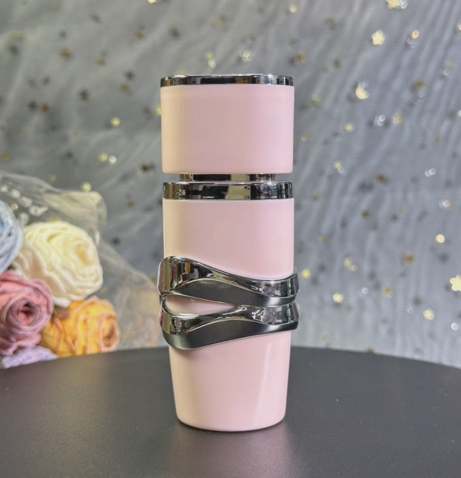 AI-assisted example of the Pink 30ml travel-fragrance option being sprayed toward a wrist